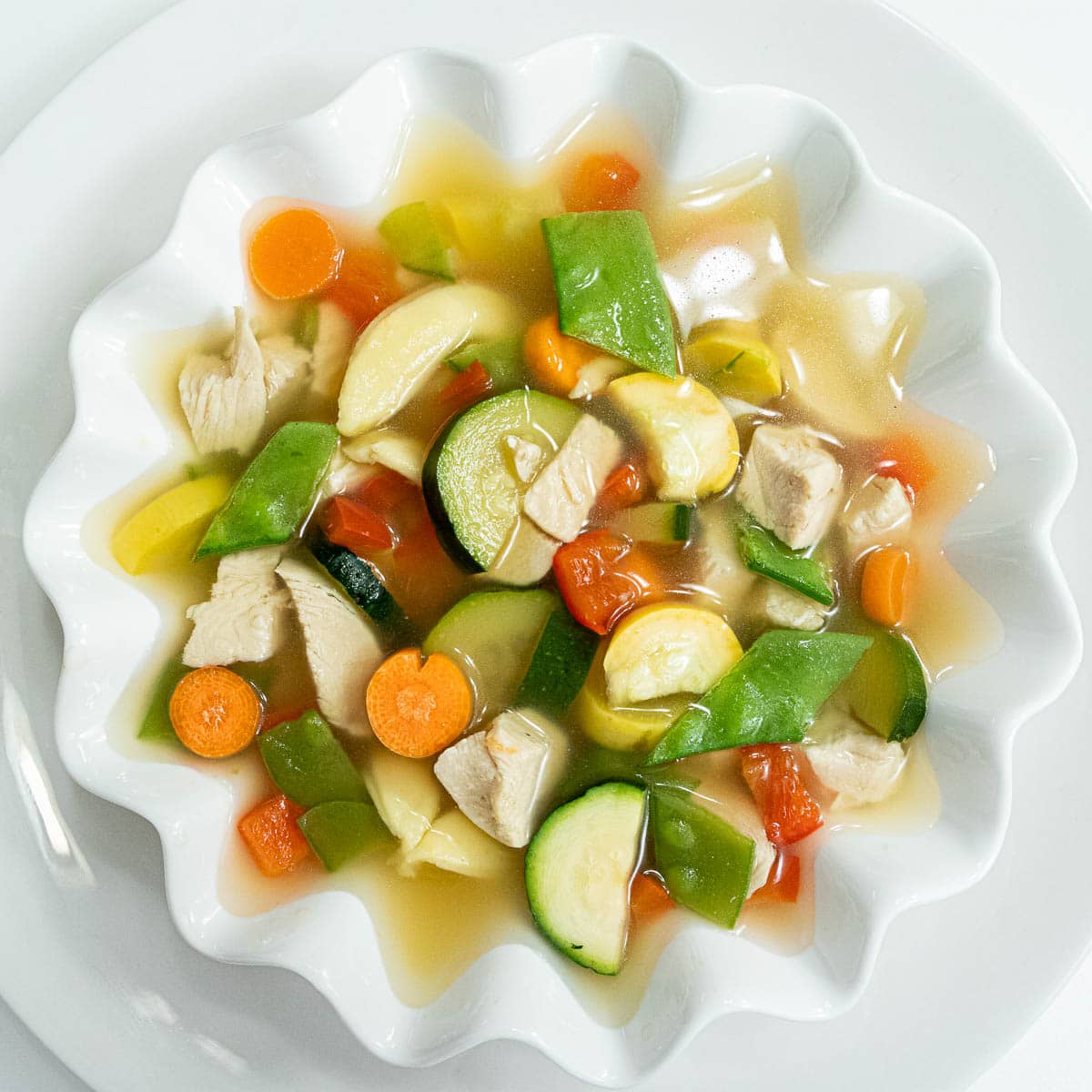 Spoo is a light, easy to make chicken soup with carrots, zuchinni, snow peas, carrots, yellow squash, and red peppers.