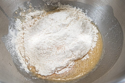 Flour in bowl with liquid ingredients for the Fig Stuffed Anise Sweet Bread