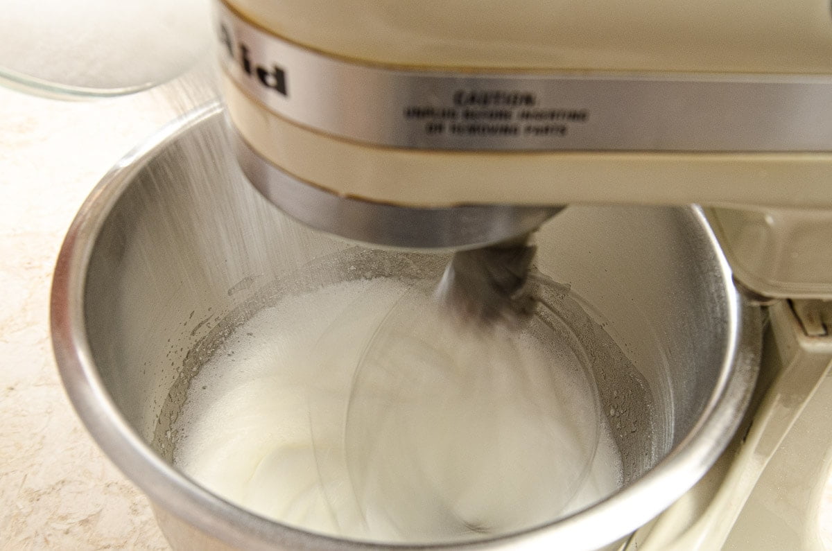 Adding sugar to the egg whites