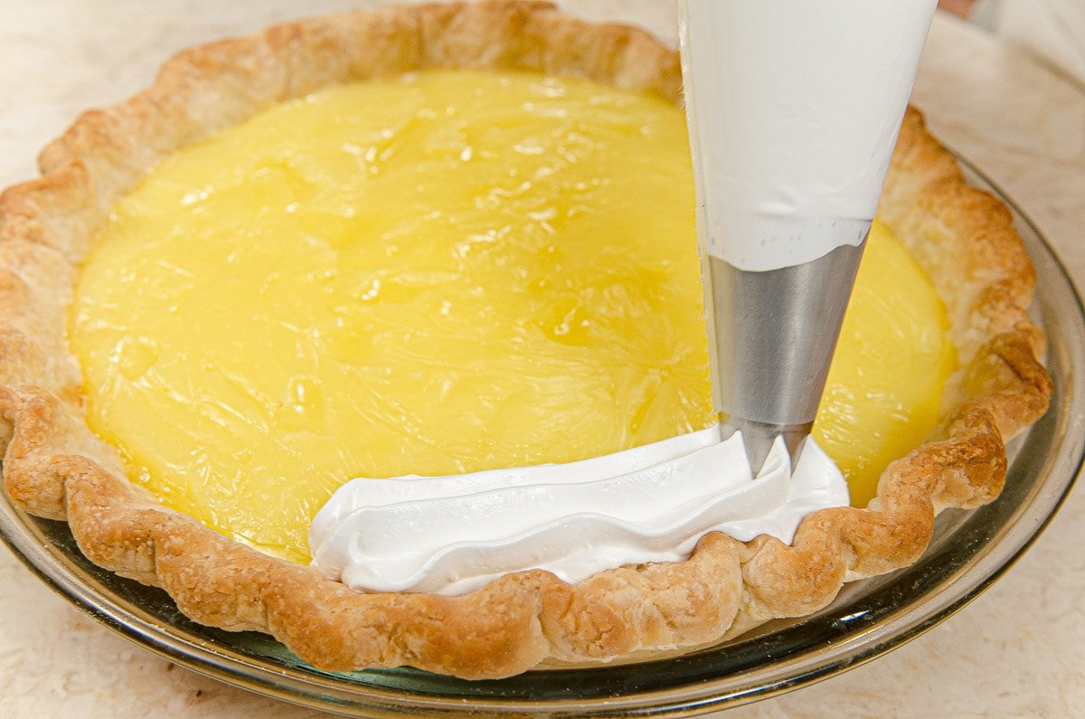 Piping meringue on inside edge of pie crust