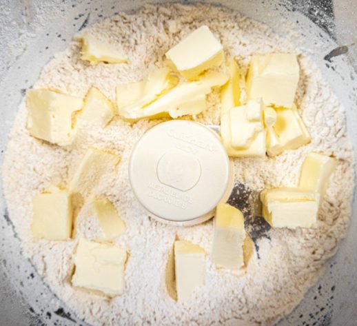 Butter added to flour mixture in the processor
