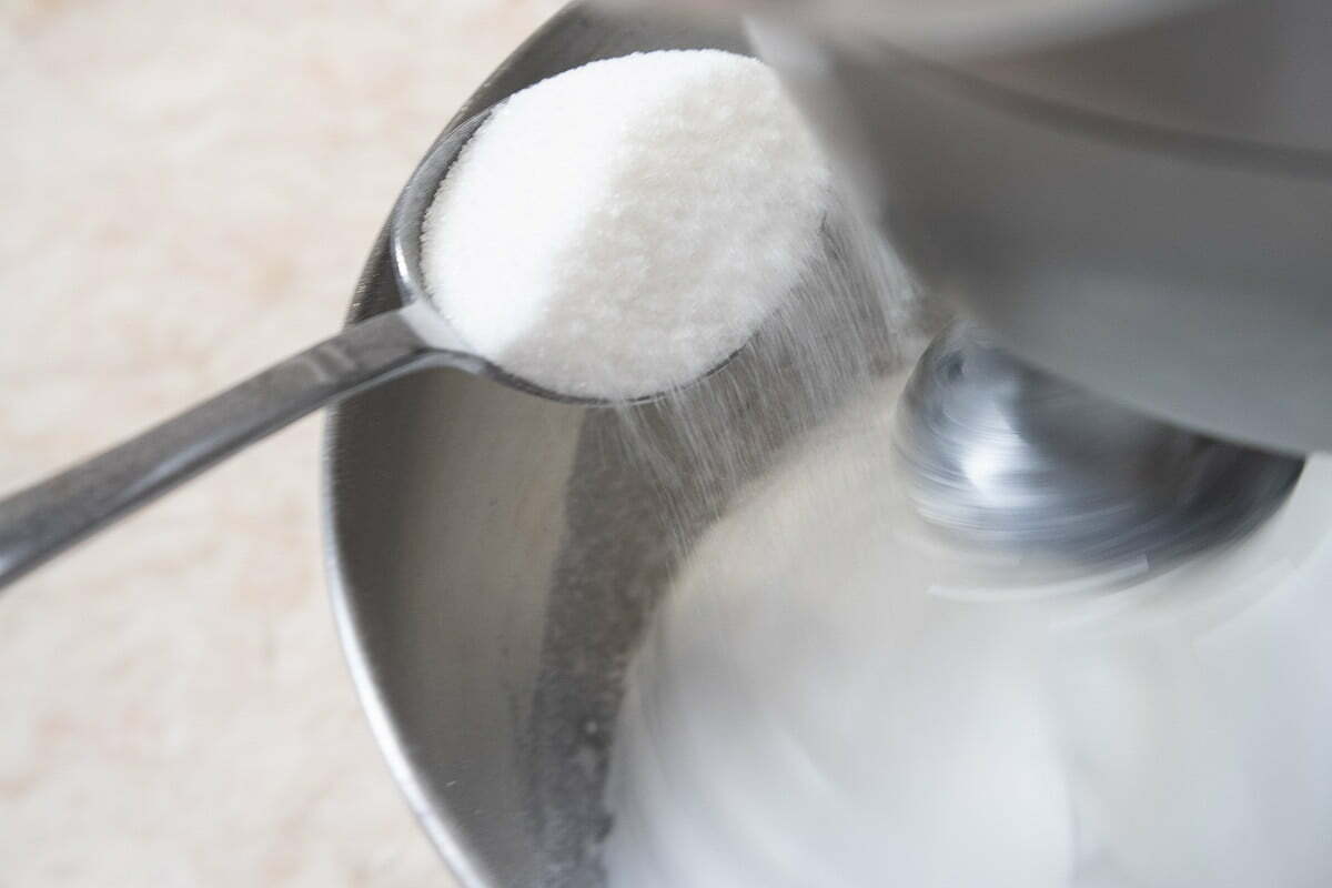 Adding sugar to the egg whites