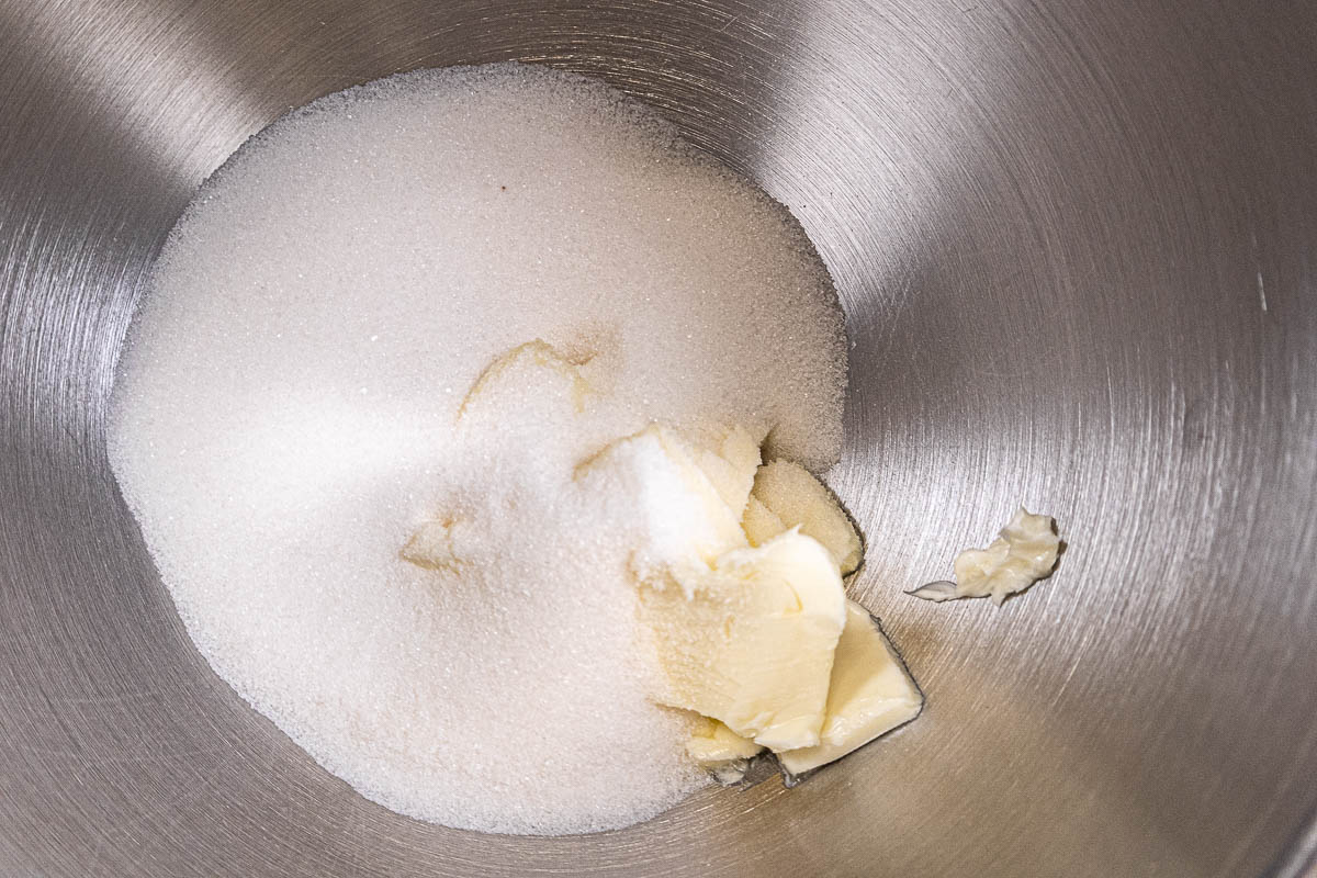 Butter and sugar in the bowl of a mixer.