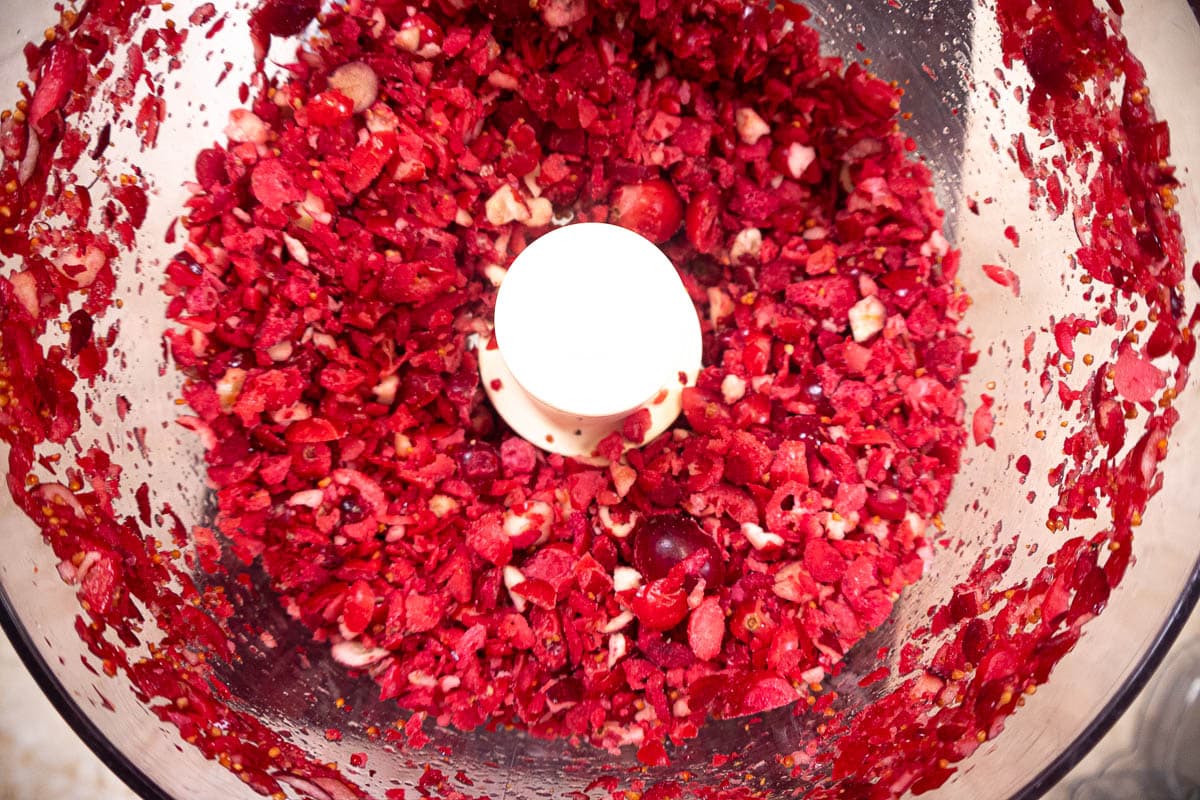 The cranberries are pulsed in the processor until chopped into smaller pieces.