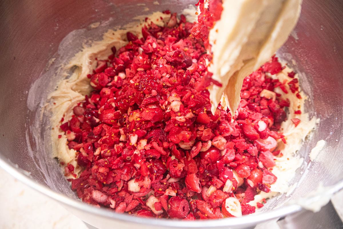 The cranberries are added to the batter in the mixing bowl.