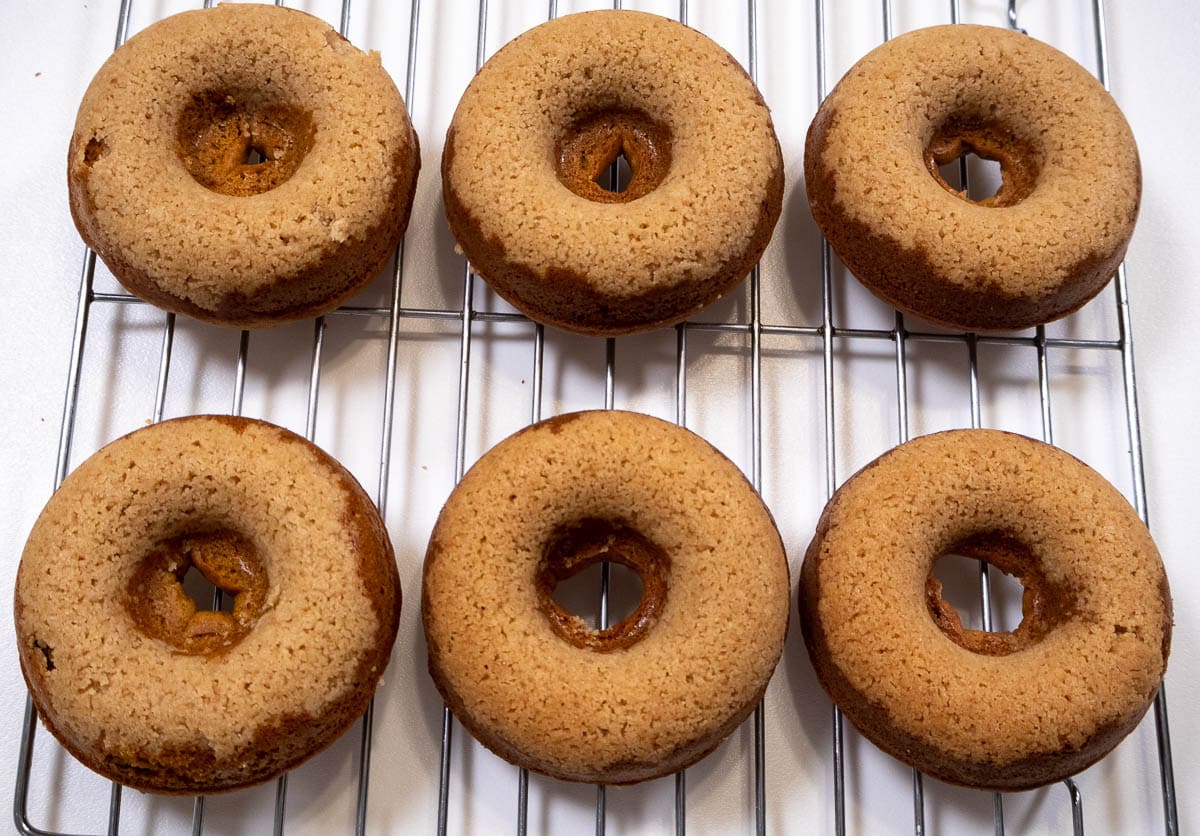 Baked Pumpkin Donut Cake Recipe donuts on a cooling rack