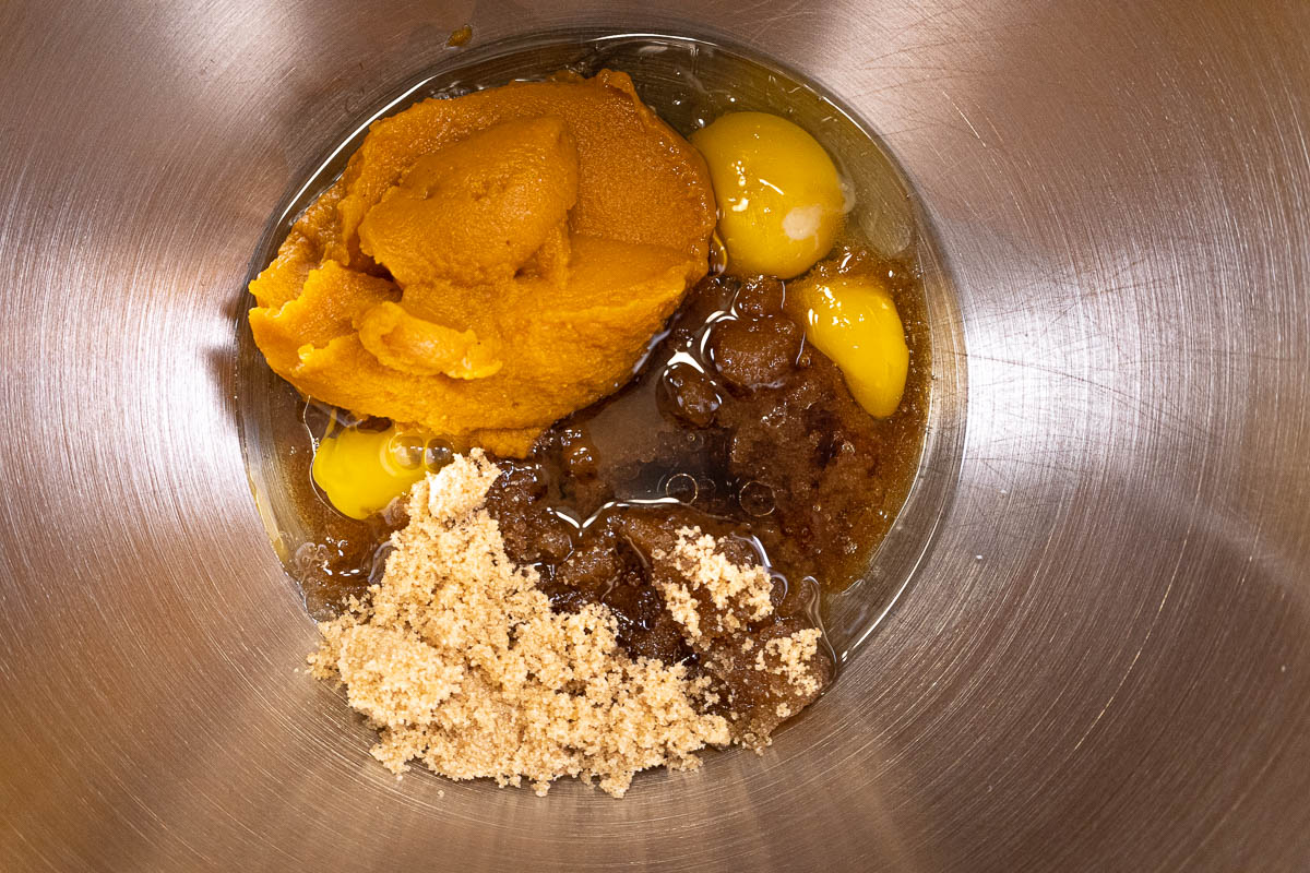 The oil, eggs, sugar, pumpkin puree and vanilla in a mixing bowl for the Pumpkin Cake Donut Recipe