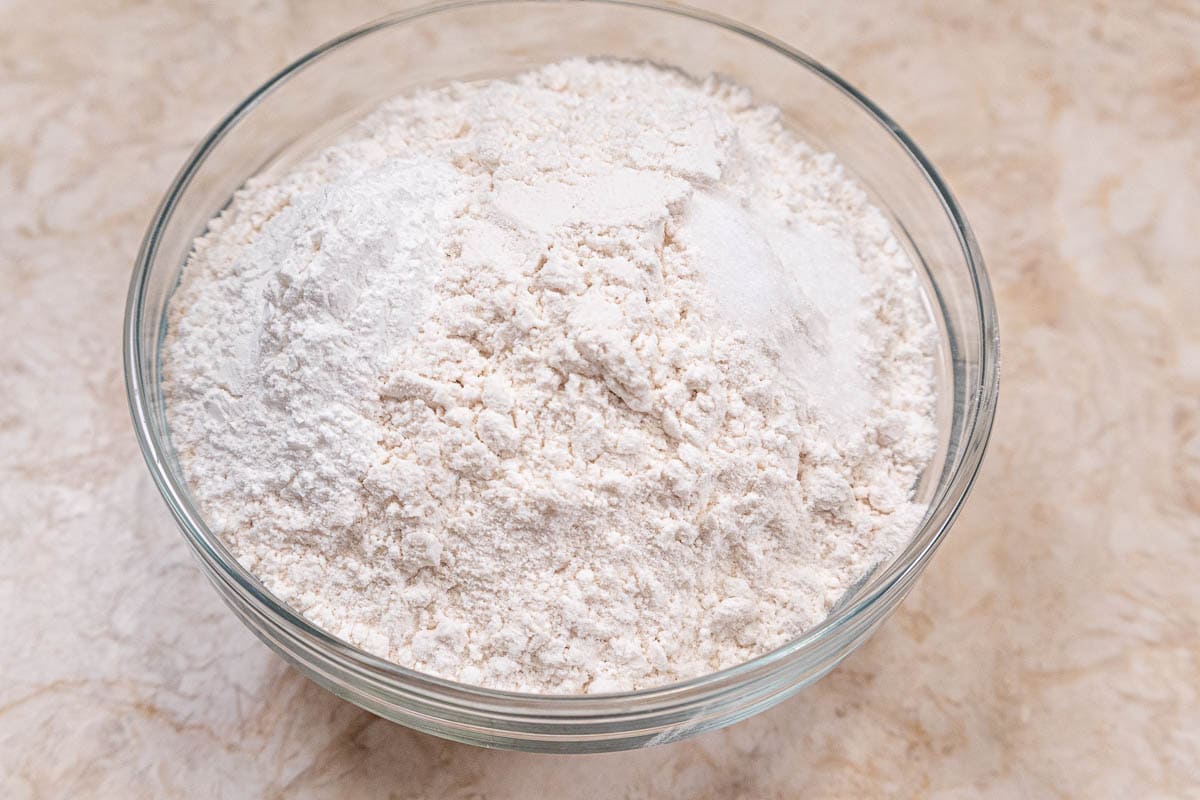 The flour, baking powder and salt in a bowl to be mixed.