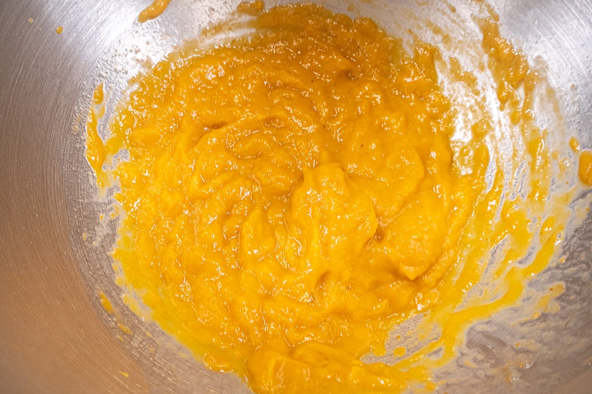 The pumpkin, egg and vanilla mixed together in the mixing  bowl.