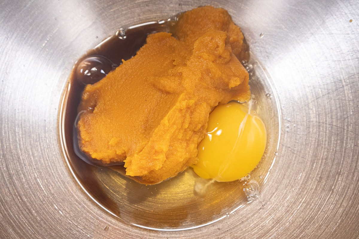 The pumpkin, egg and vanilla in the mixing bowl