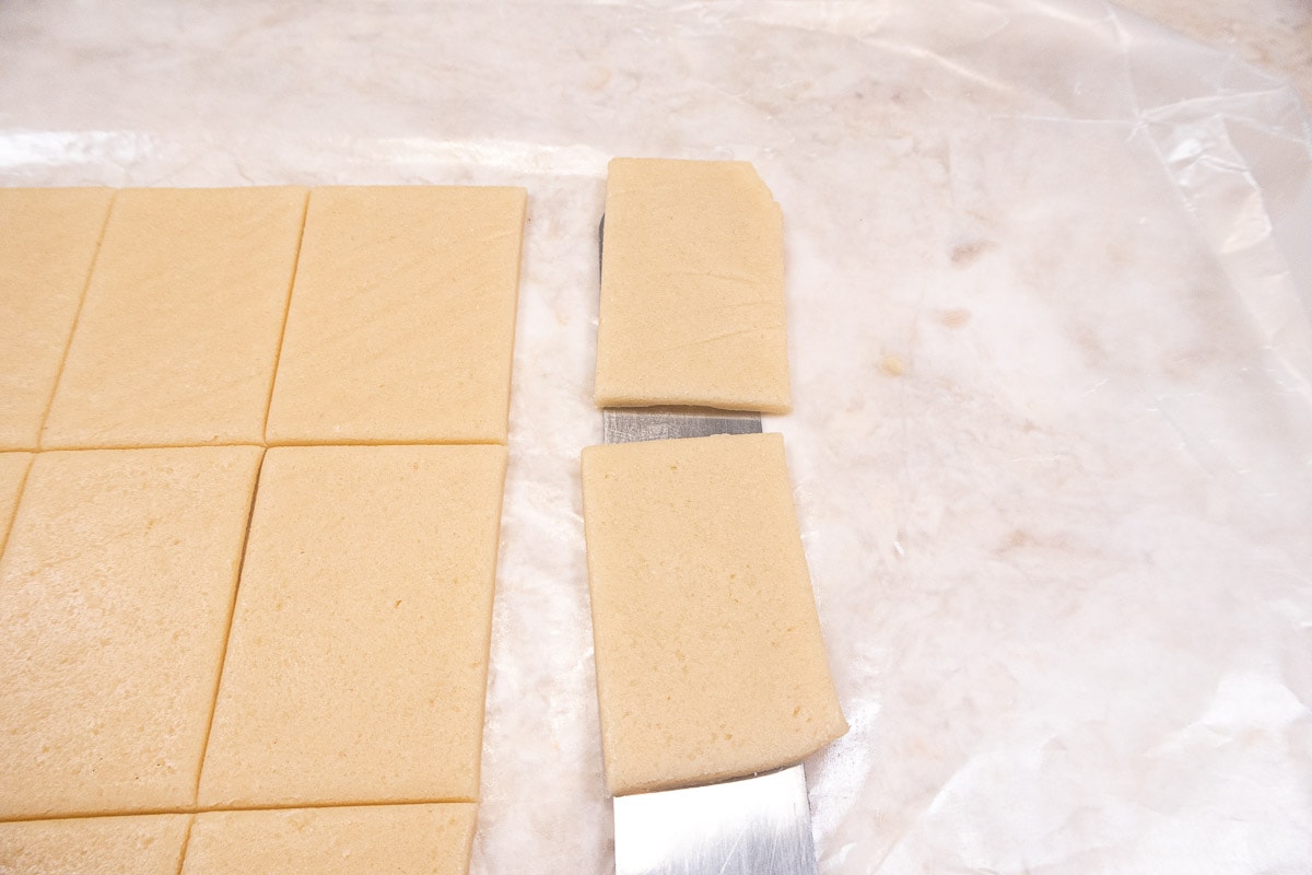 Lifting the frozen cookie off the waxed paper with an offset spatula