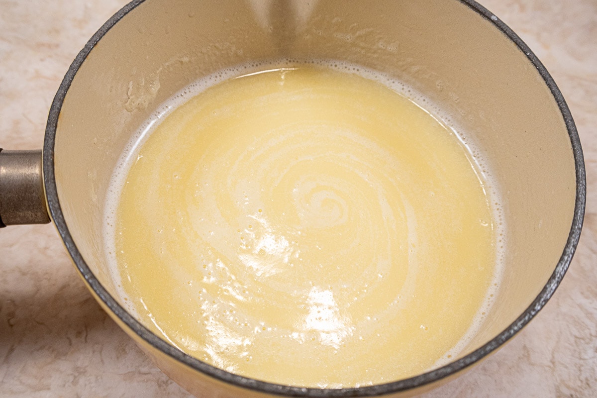 The milk, butter, honey and potato flakes cooling in the saucepan.