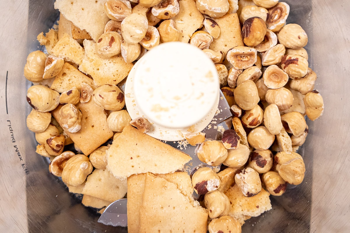 Half the cookies and half the nuts are in the processor bowl.