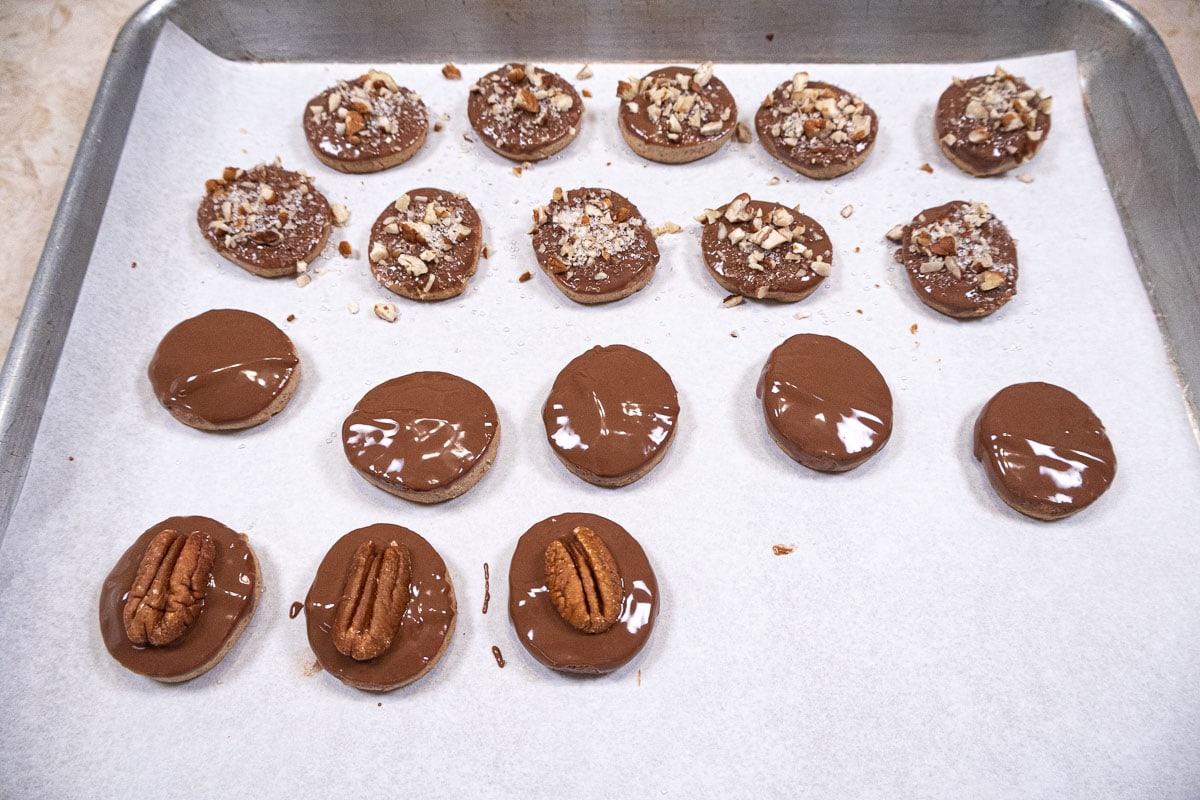 The Pecan cookies are dipped in chocolate and left plain, topped with a pecan and with the sugar-pecan mix