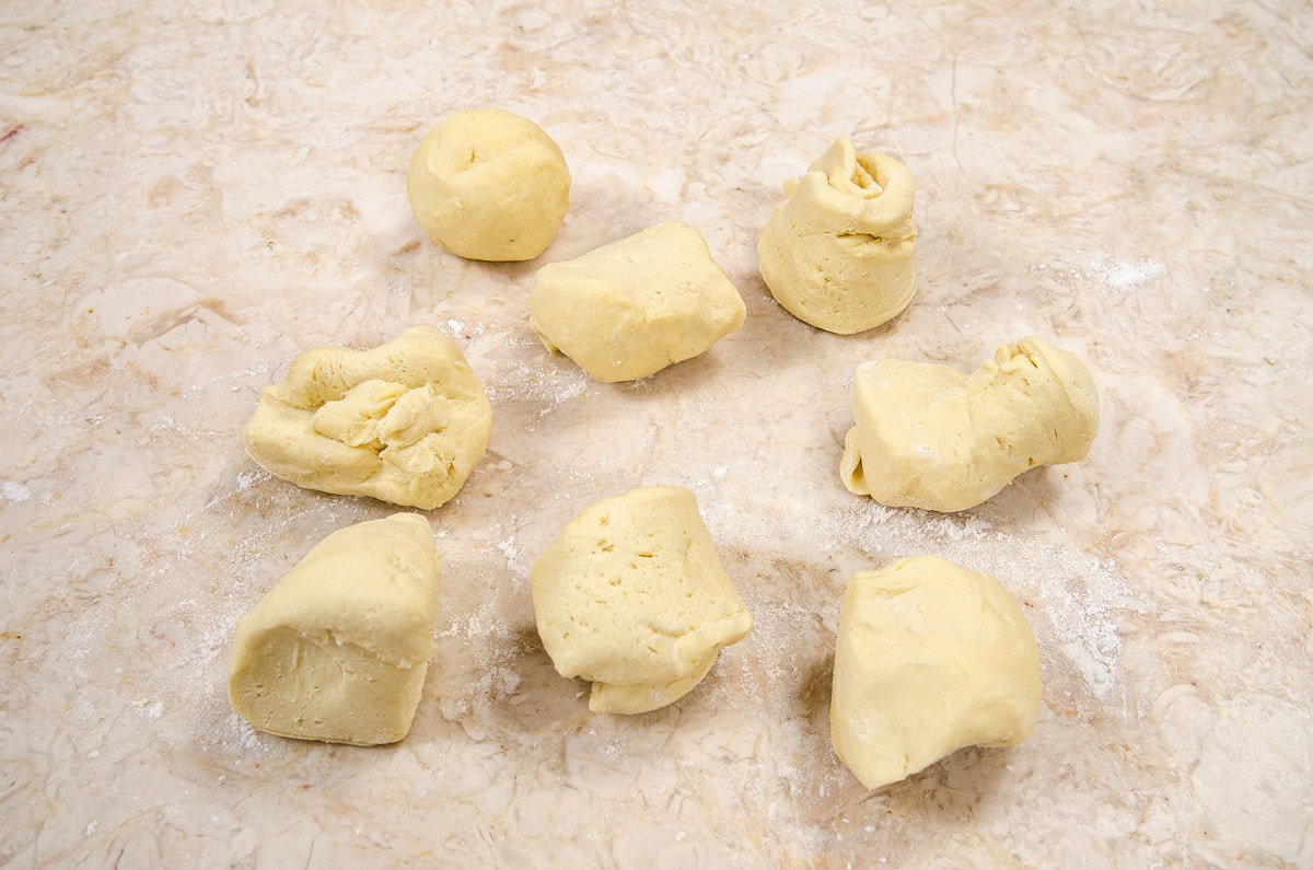The dough is divided into 8 pieces about 85 grams or 3 ounces each.