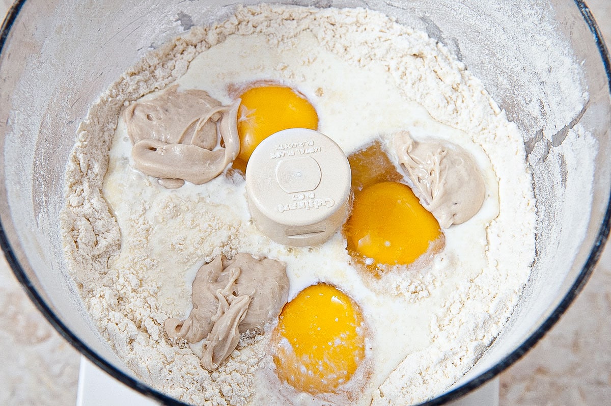 The eggs, cream and  yeast are added to the processor bowl.