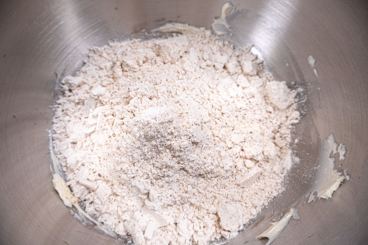 The flour mixture is added to the butter in the mixing bowl