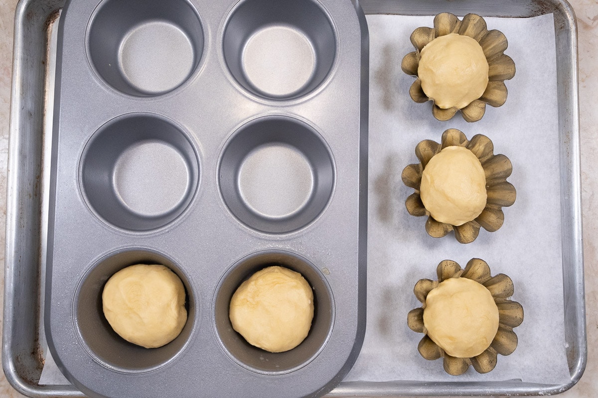 The rolls have been place in brioche forms and in Texas muffin cups.
