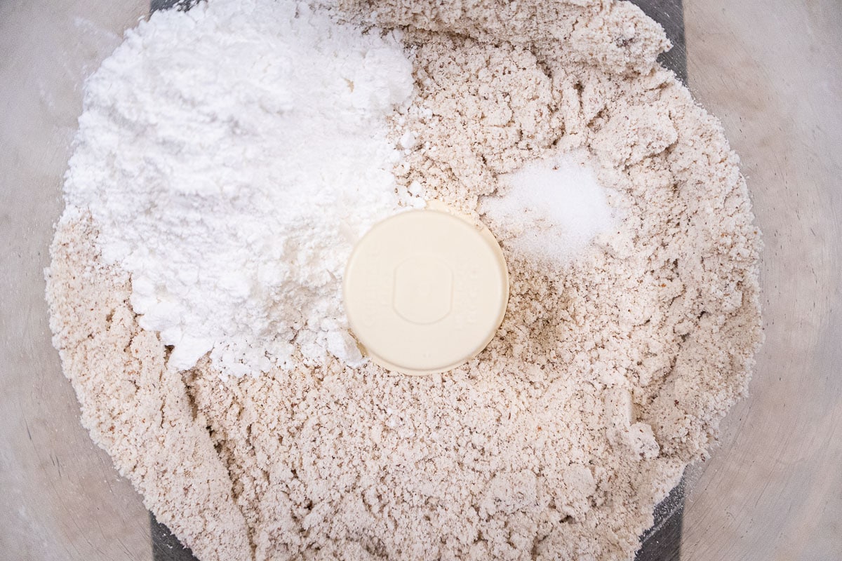 The powdered sugar and salt are added to the processor bowl.