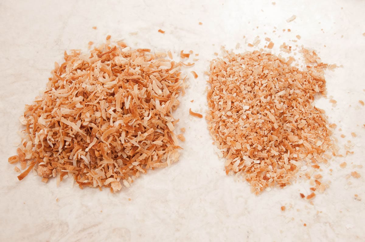 Two piles of coconut, one crushed and one with longer strand, uncrushed