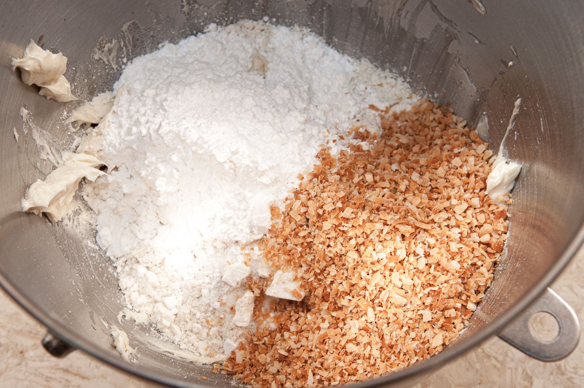 The remaining ingredients, flour/nut mixture,powdered sugar, macadamia nuts, and salt are added to the mixing bowl.