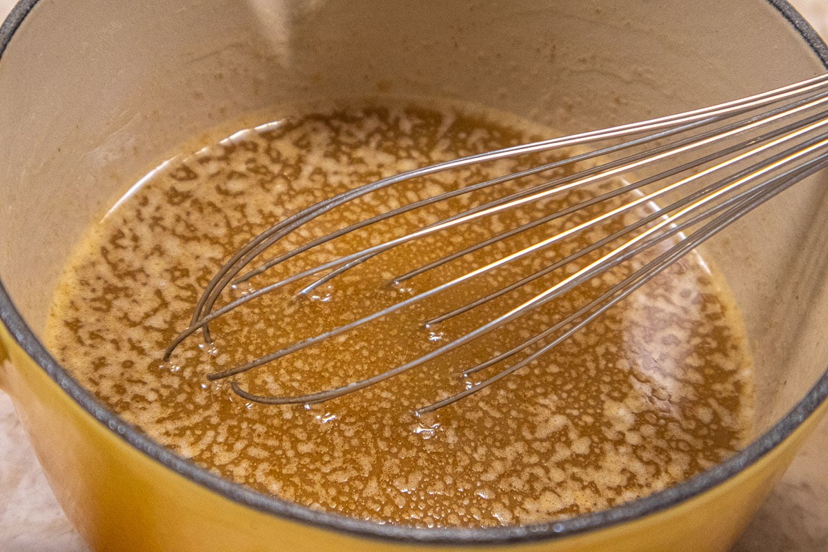 The molasses is whisked into the melted butter.