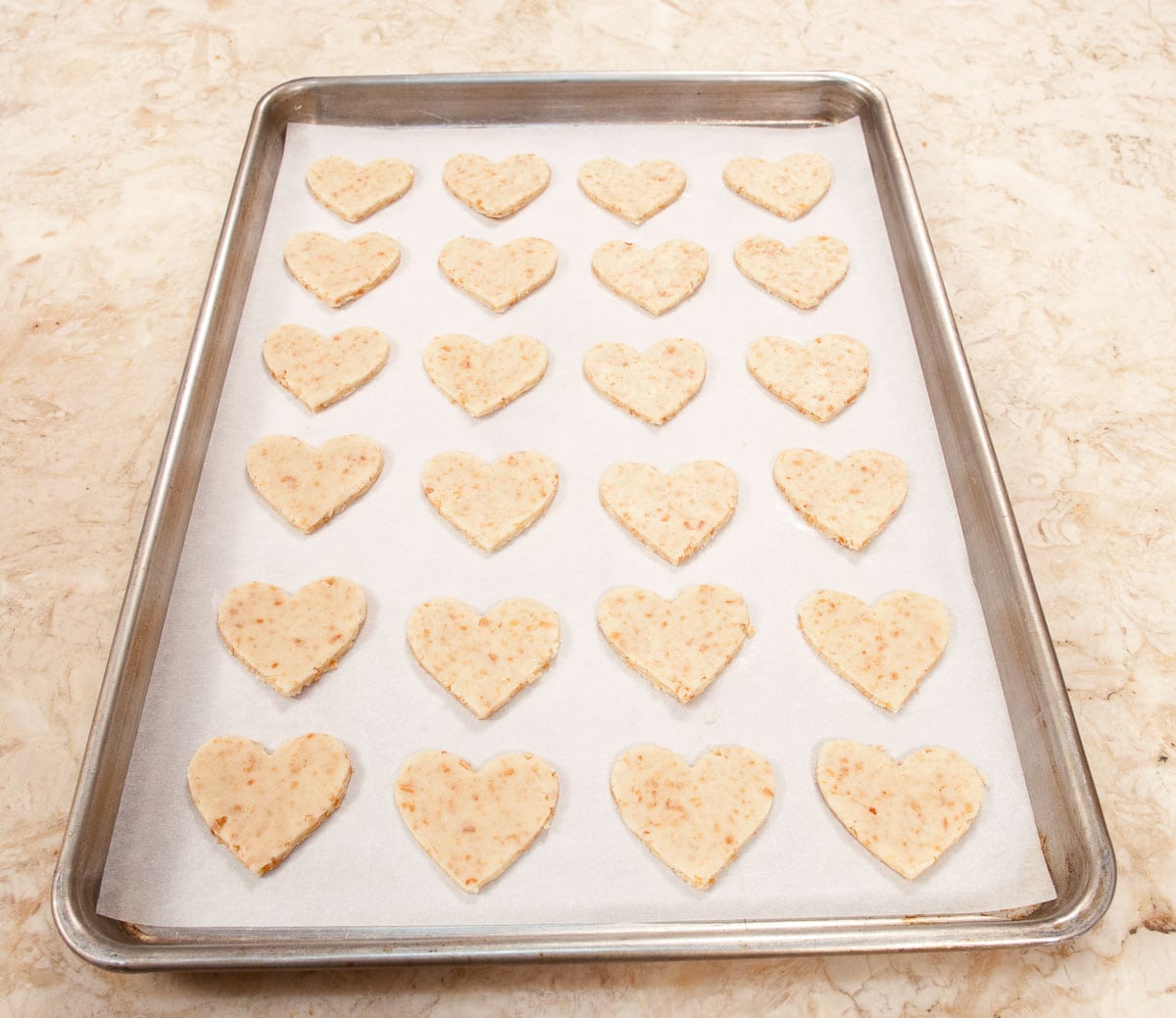 Tray of cut out hearts ready to go into the oven.