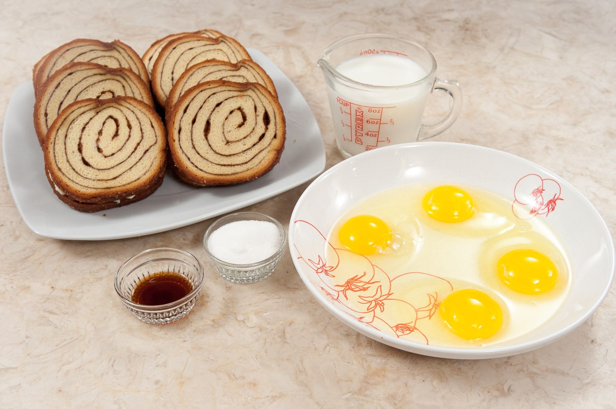 Egg mixture ingredient include cinnamon bread,milk,vanilla, sugar and eggs in a bowl.