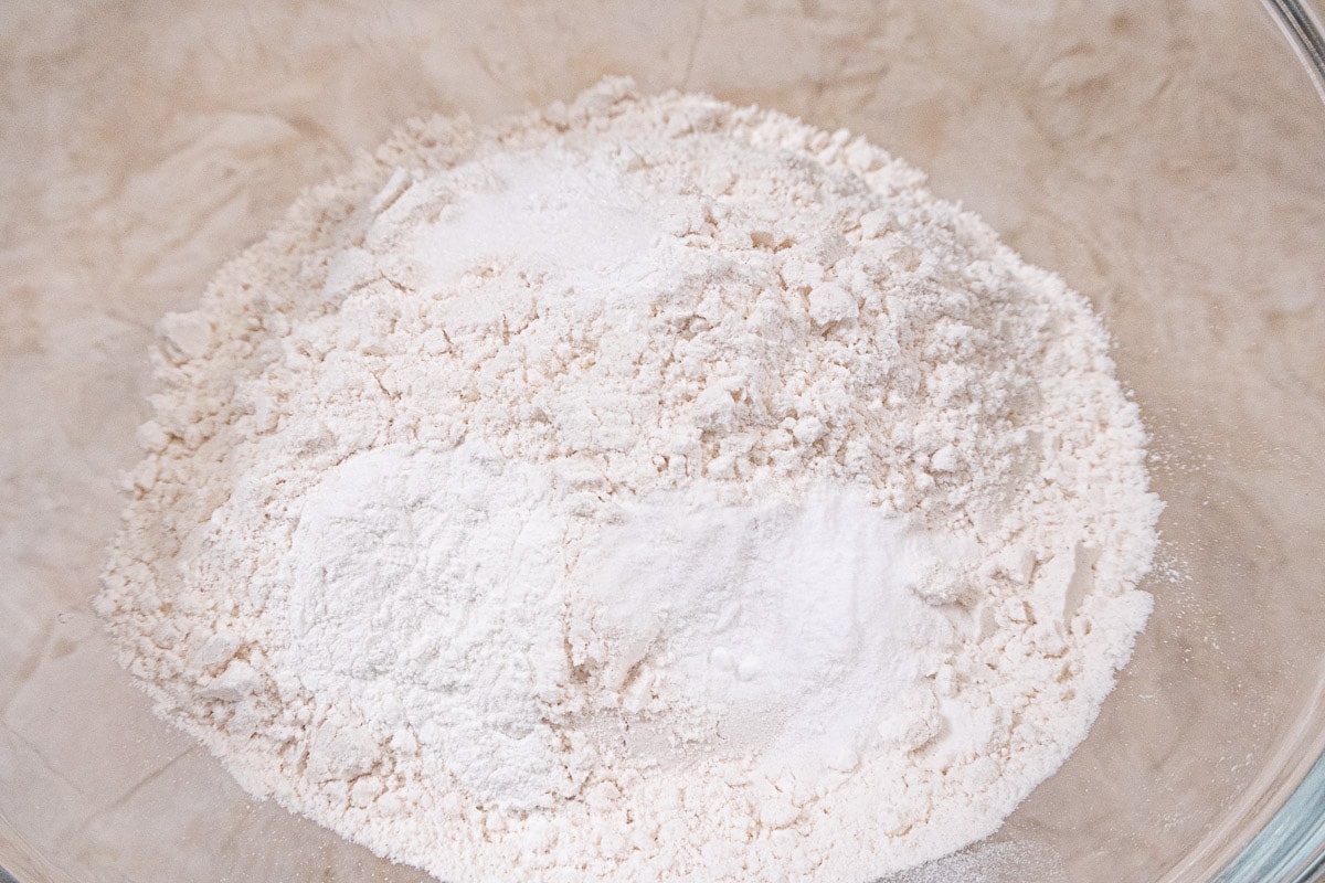 The flour, salt, baking powder and baking soda are in a bowl.
