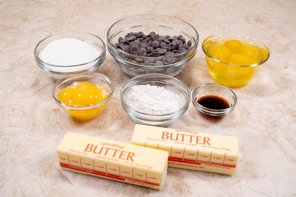 Ingredients for the Warm Chocolate Lave cakes include sugar, semisweet chocolate, whole eggs, egg yolks, flour, vanilla and butter.