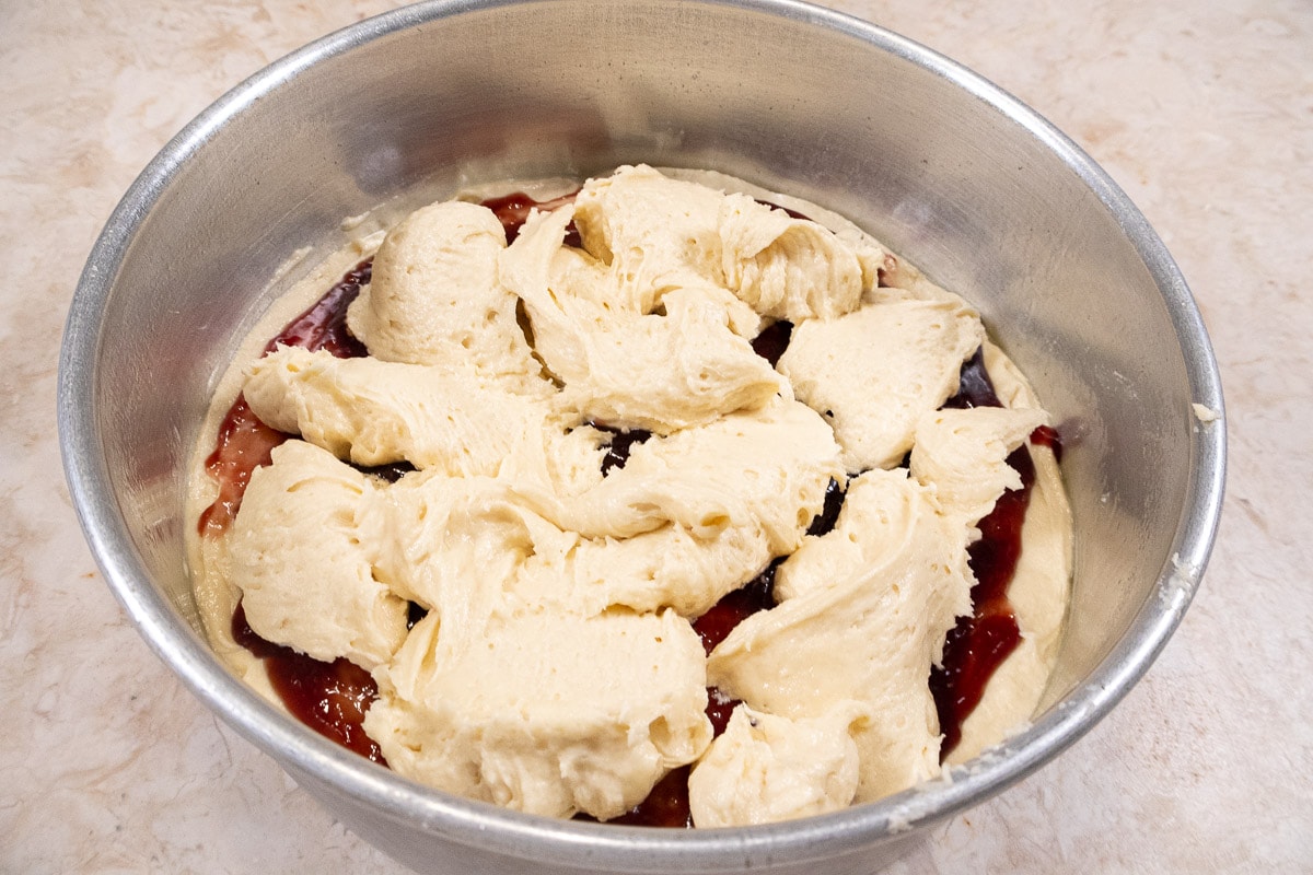 The top batter is dolloped over the raspberry filling.