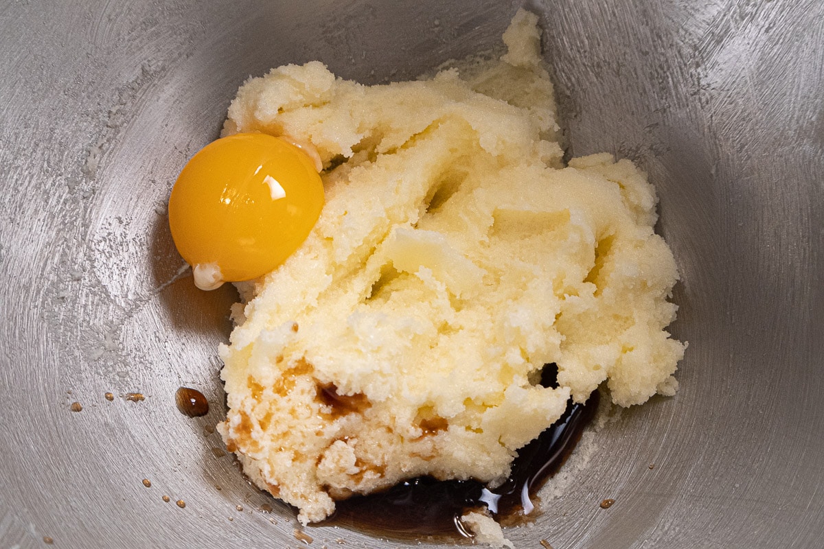 The egg yolk and vanilla  are added to the creamed butter and sugar.