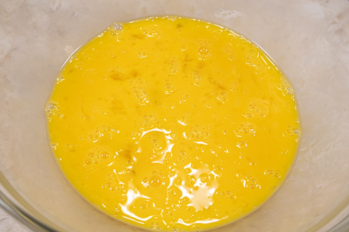 The eggs and yolks are whisked together until well mixed.