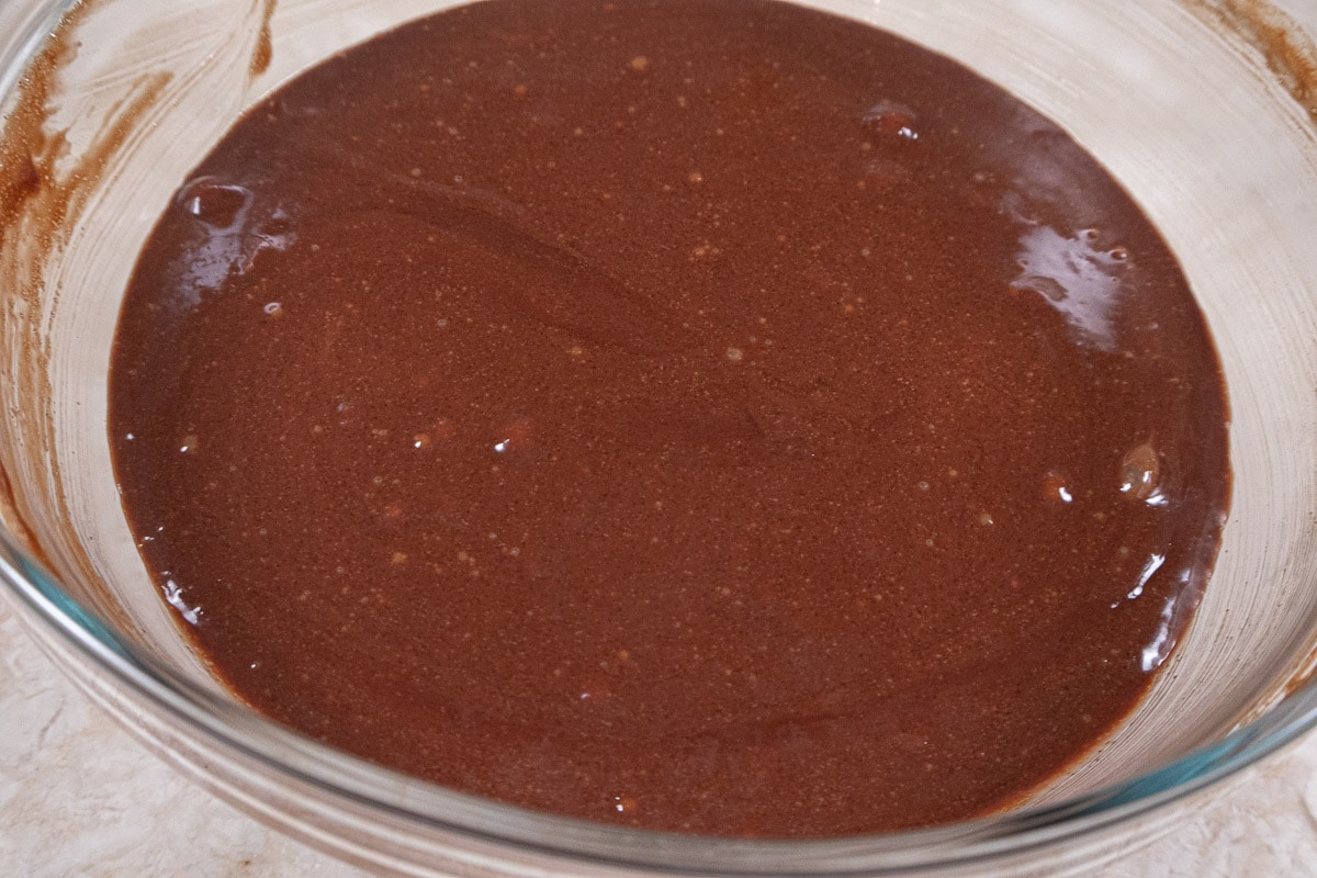 The sugar and vanilla are whisked into the chocolate mixture.