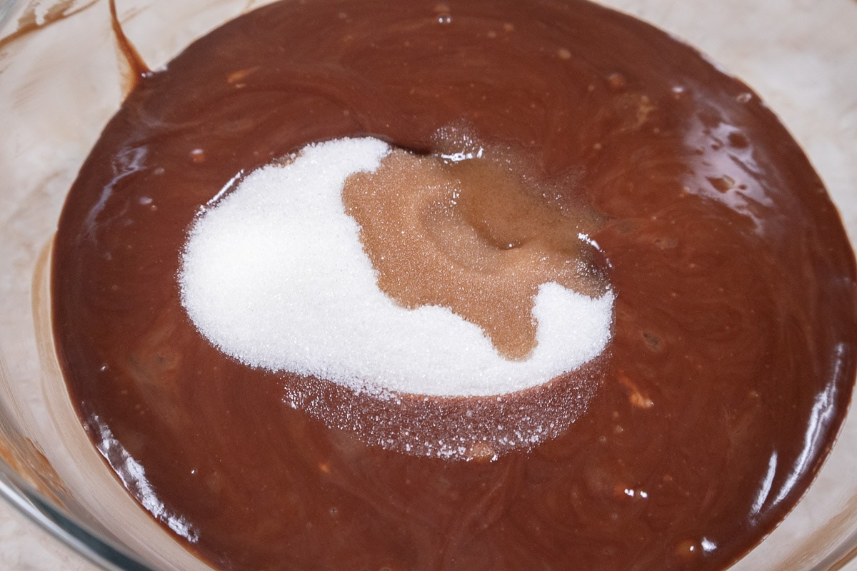 The sugar and vanilla are added to the chocolate/butter mixture.