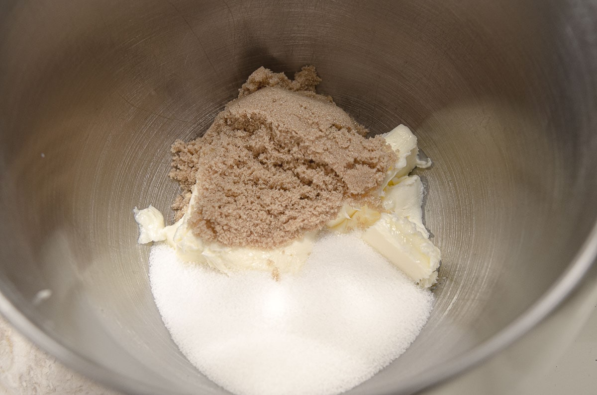 The brown and granulated sugars and butter are in the mixing bowl.