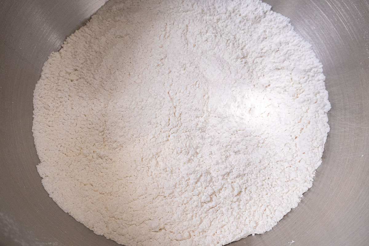 The cake flour,sugar, baking powder and salt are placed in the bowl of a mixer.