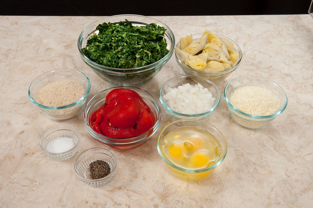 Ingredients for the Torta Rustica shown are, bread crumbs, spinach, artichokes, red peppers, onions, parmesan cheese, salt, pepper and eggs.