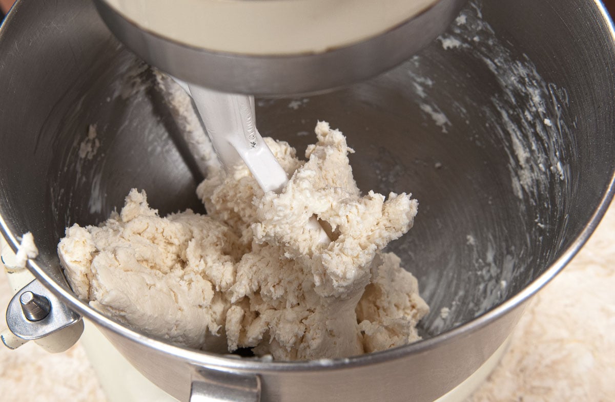 The dough is combined in the mixer.