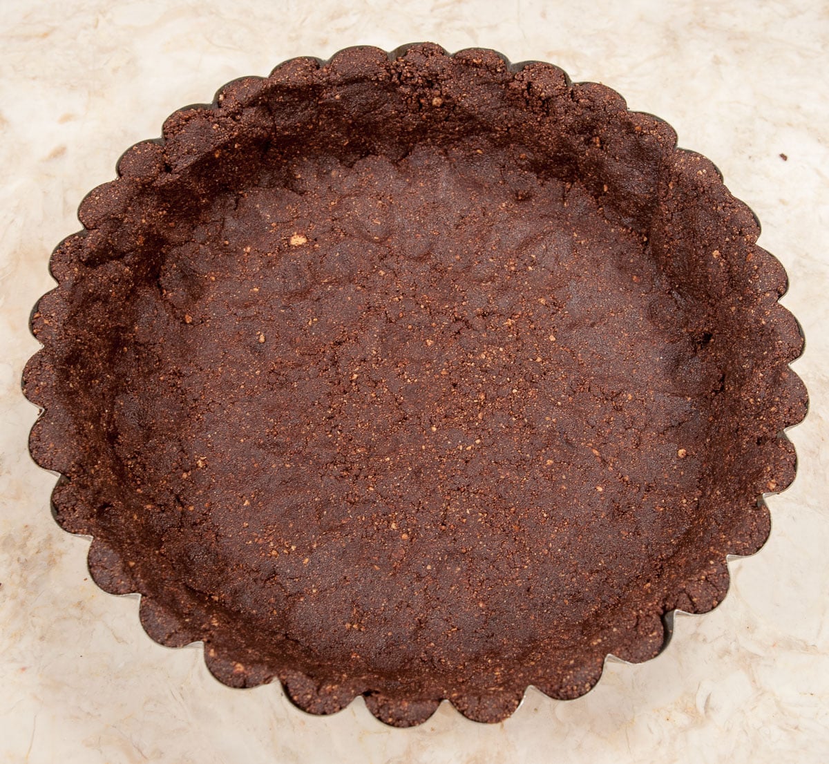 The remaining ⅓ of the crumbs are pressed into the bottom of the pan.