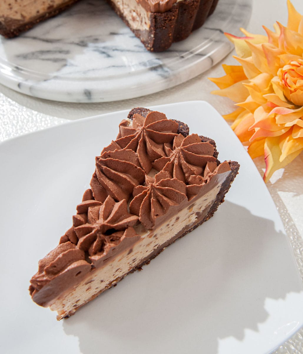 An overhead view of a slice of Snickers Pie on a plate.