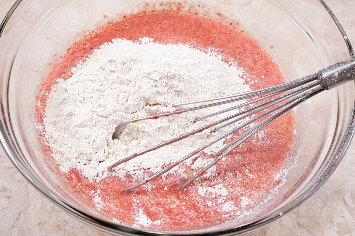 The flour mixture is added to the wet ingredients in the bowl.