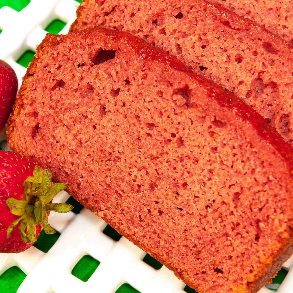 Slices of Strawberry Bread on a lattice plate.