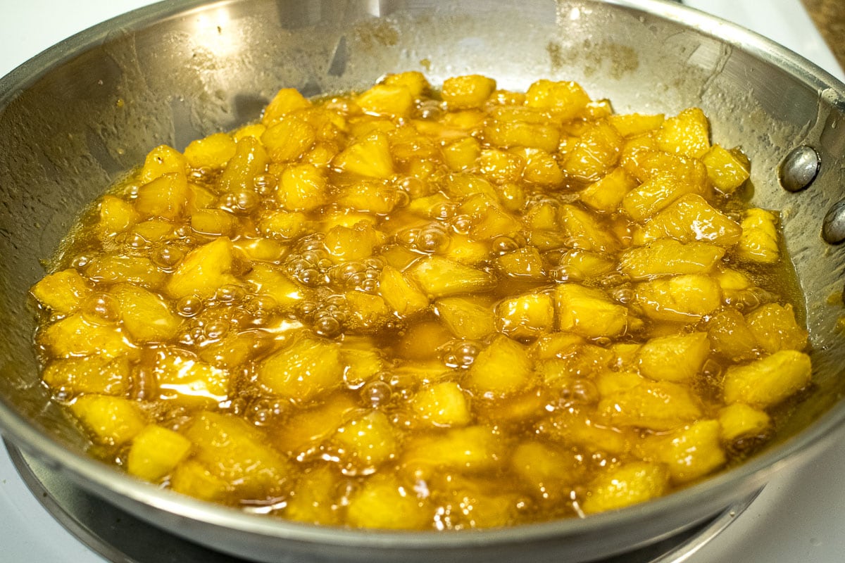 The fresh pineapple is added to the syrup.