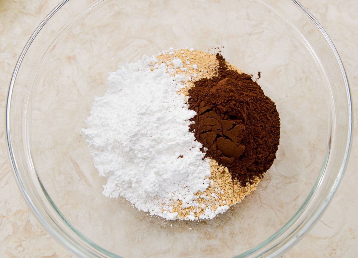The graham cracker crumbs, powdered sugar and cocoa are in a bowl.
