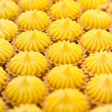 Rows of lemon curd tartlet petit fours.