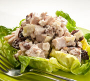 The Smoked Turkey Salad is served in a lettuce cup on a green plate with a fork.
