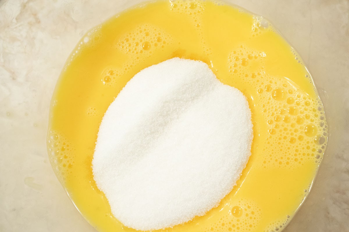 The sugar and lemon juice are added to the whisked eggs.