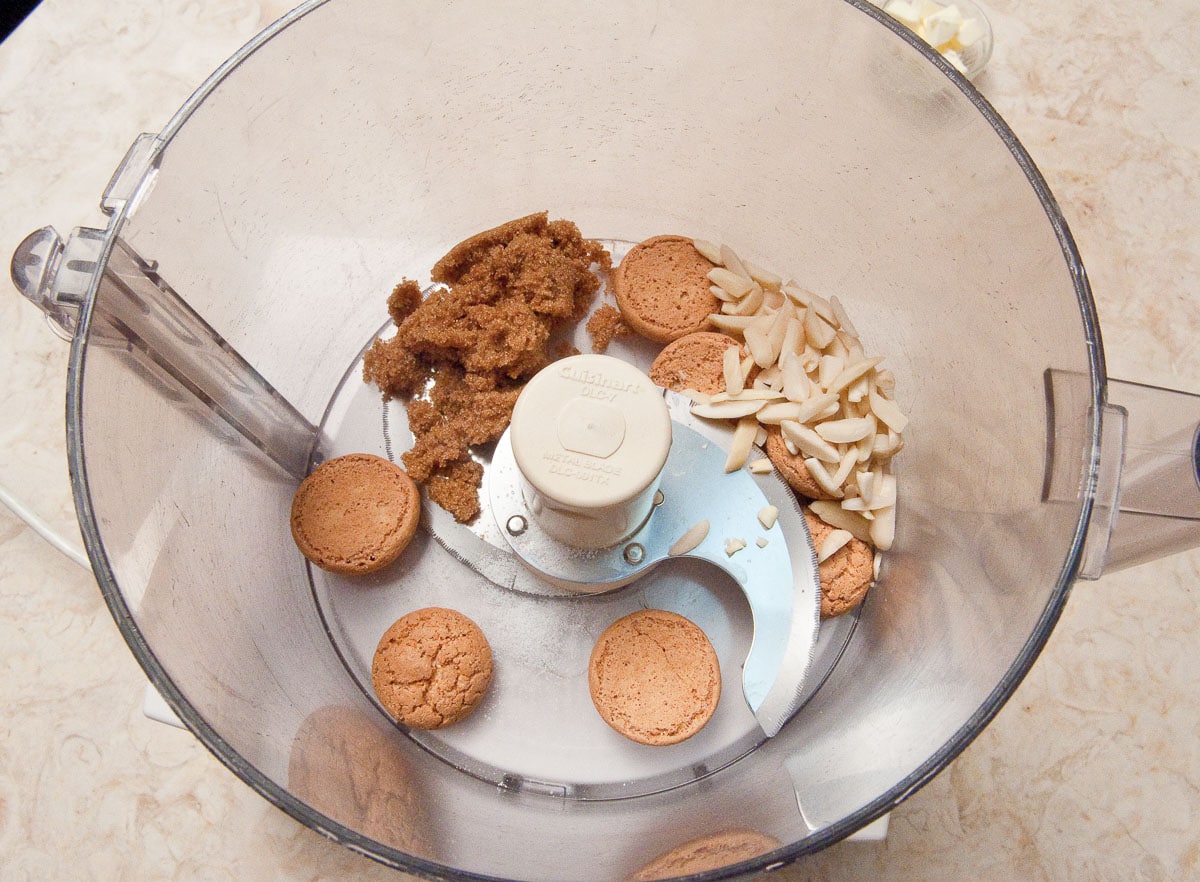 The amaretti cookies, almonds, brown sugar and salt are placed in the bowl of a processor.