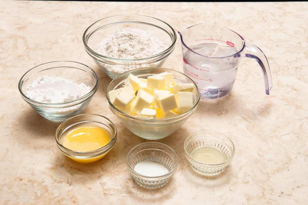 All-purpose flour, cake flour, salt, unsalted butter, egg, lemon juice and cold water make up the pâte brisée crust.